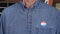 Senior caucasian man in working clothing with Voted sticker