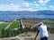 A senior Caucasian white man taking photograph of the landscape overlooking the vineyards and farmland in Okanagan Lake, West