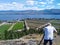 A senior Caucasian white man taking photograph of the landscape overlooking the vineyards and farmland in Okanagan Lake, West