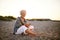 Senior caucasian woman with cell phone on the beach