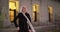 Senior Caucasian woman dancing on building steps in evening having fun