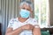 Senior caucasian woman in face mask showing plaster after vaccination