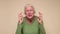 Senior caucasian woman gesturing finger crossed, smiling with hope.