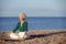 Senior caucasian woman meditating on the beach