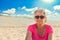 Senior Caucasian Woman Portrait on Sandy Sunny Beach Background