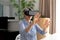 Senior Caucasian woman putting on a VR headset at home