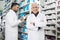 Senior Chemist Standing Arms Crossed While Colleague Counting St