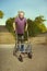 Senior citizen going with help of his four wheel rollator walker