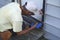 Senior citizen handyman working on a new storm door in Greenbelt, Maryland
