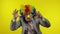 Senior clown businessman entrepreneur boss making silly faces. Yellow background