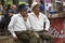 Senior colombian men sitting in a park, Medellin