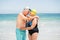 Senior couple with bathing cap at the beach