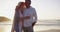 Senior couple, beach and hugging in sunset and married on holiday, outdoor and retired. Retirement, elderly and love for