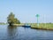 Senior couple with bicycles leaving foot ferry after crossing canal near Grou, Friesland, Netherlands