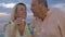 Senior couple blowing bubbles at the seaside