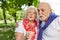 Senior couple blowing dandelion seeds