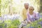 Senior couple in bluebell woods