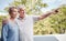 Senior couple, bonding or pointing on house balcony or home garden trees, backyard plant growth or Australian wild