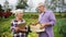 Senior couple with box of vegetables on farm