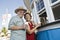 Senior Couple Buying Drinks At Food Stand