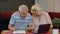 Senior couple checking calculating bills bank loan payment doing paperwork discuss unpaid debt taxes