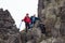 Senior couple with child trekking on the rock