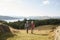 Senior Couple Climbing Hill On Hike Through Countryside In Lake District UK Together