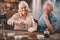 Senior couple cooking together at kitchen table