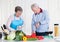 Senior couple cutting vegetables