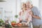 Senior couple cutting vegetables