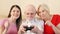 Senior couple and daughter gamers playing video game at home. Happy family enjoying time together