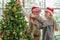 Senior couple decorate Christmas tree together in Christmas festival