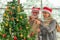 Senior couple decorate Christmas tree together in Christmas festival