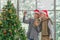 Senior couple decorate Christmas tree together in Christmas festival