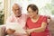 Senior Couple Discussing Document At Home