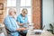 Senior couple with documents and laptop at home