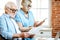 Senior couple with documents and laptop at home