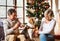 Senior couple with dog in front of Christmas tree