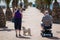 Senior Couple and Dog Strolling on Seaside Promenade