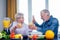 Senior couple drinking vegan smoothie with organic fruits and vegatables from eco glasses and reusable tubes,high five