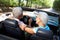 Senior couple driving in sports car