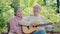 senior couple elderly man playing the guitar while his wife is singing together