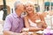 Senior Couple Enjoying Coffee And Cake