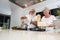 Senior couple enjoying and cooking healthy dinner together at home - Happy mature people preparing food to dine in the kitchen -