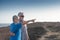 Senior couple enjoying sea excursion on the cliffs looking at the horizon over water. Active retired elderly people wellness