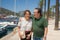 Senior couple enjoying travel getaway - happy and sweet mature husband and wife enjoying retirement walking on sea harbor at