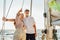 Senior couple enjoying the view on private sailboat.