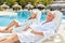 Senior couple enjoys the luxury summer vacation by the pool