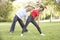 Senior Couple Exercising In Park