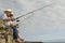 Senior Couple Fishing Against Cloudy Sky